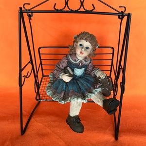 Ceramic school girl on swing